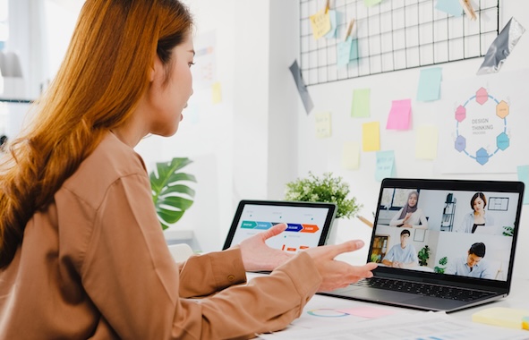 asia businesspeople using laptop talk colleagues discussing business brainstorm about plan video call meeting new normal office